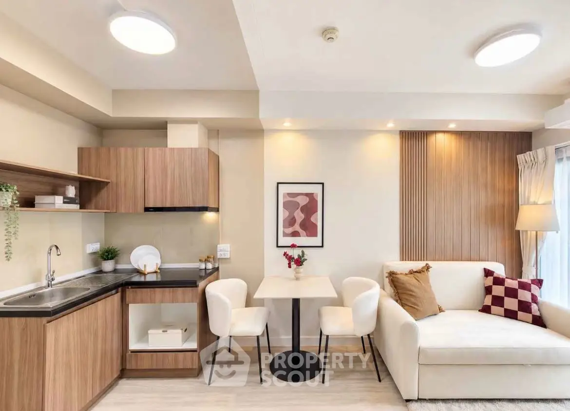 Modern open-layout living room with cozy dining area and stylish kitchen