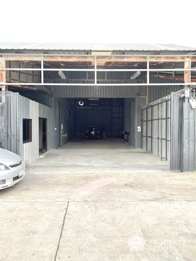 Spacious industrial warehouse with ample parking and high ceilings for versatile use.