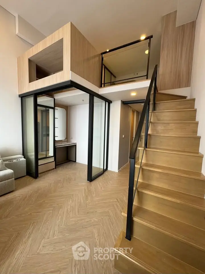 Modern loft apartment with mezzanine and stylish wooden staircase