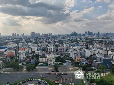 Stunning cityscape view showcasing urban skyline and residential buildings under a dramatic cloudy sky.