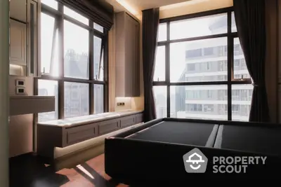 Elegant bedroom with large windows offering an abundance of natural light and a stunning city view, complemented by rich dark curtains and a cozy window seat.