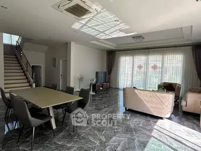 Spacious living room with modern furniture and large windows for natural light.