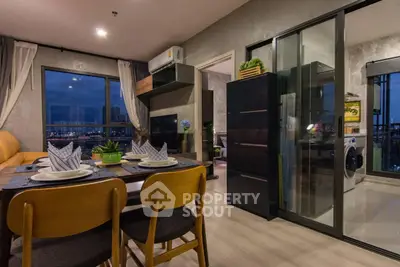 Modern open-plan living and dining area with city view and stylish decor.