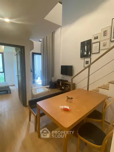 Modern duplex interior with stylish dining area and cozy living space.