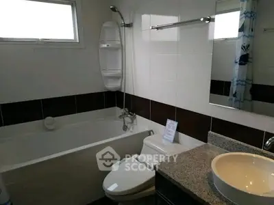 Modern bathroom with bathtub and sleek fixtures in a stylish home.