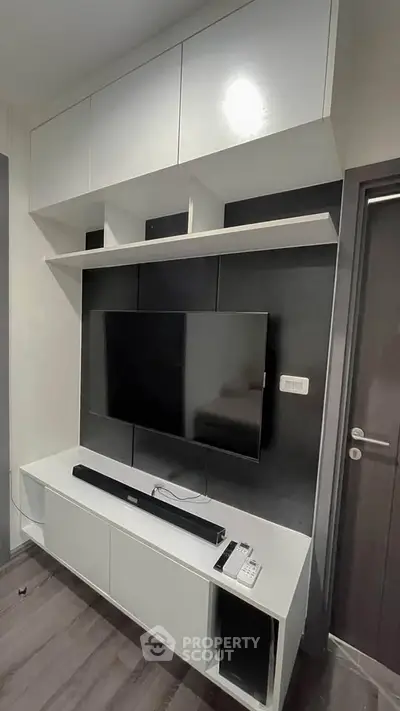 Modern living room with sleek TV unit and storage cabinets