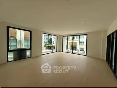 Spacious corner unit with large windows offering abundant natural light and urban views.