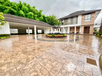 Luxurious modern home with spacious driveway and elegant landscaping, perfect for upscale living.