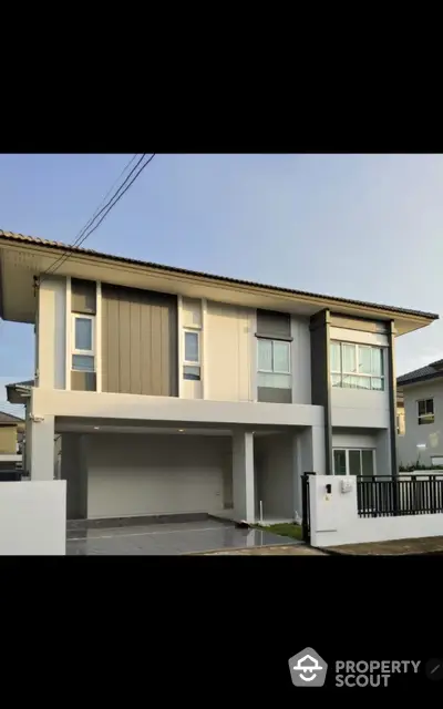 Modern two-story house with sleek design and spacious driveway