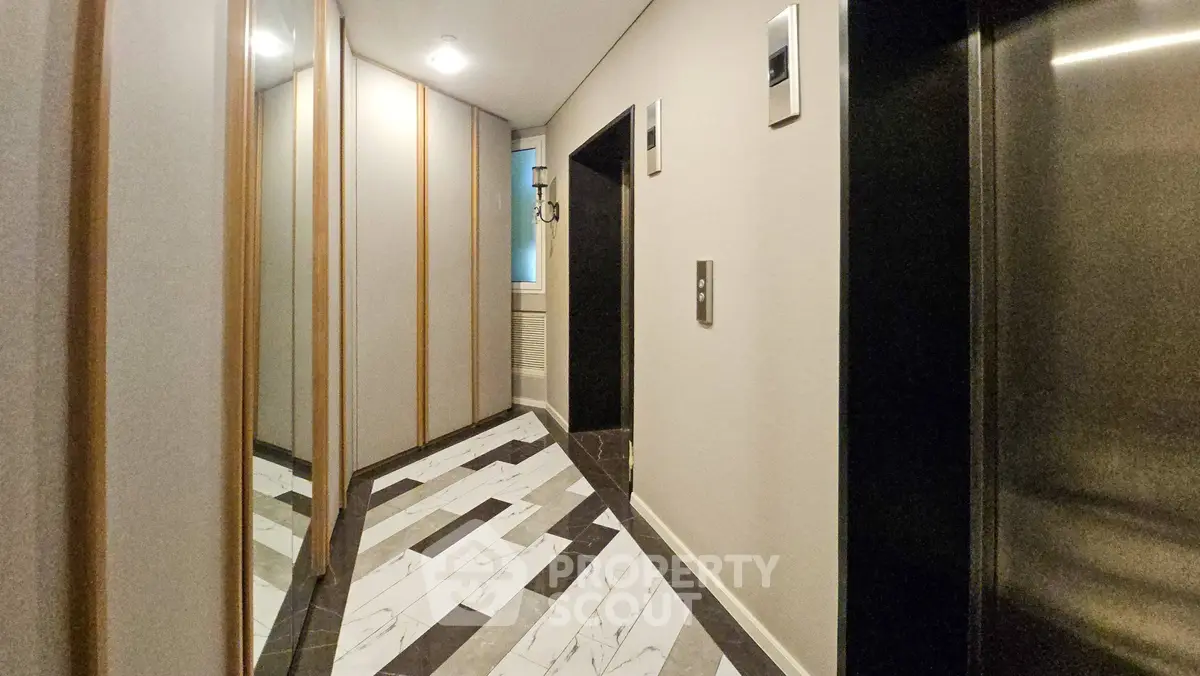 Modern apartment hallway with stylish elevator and elegant flooring