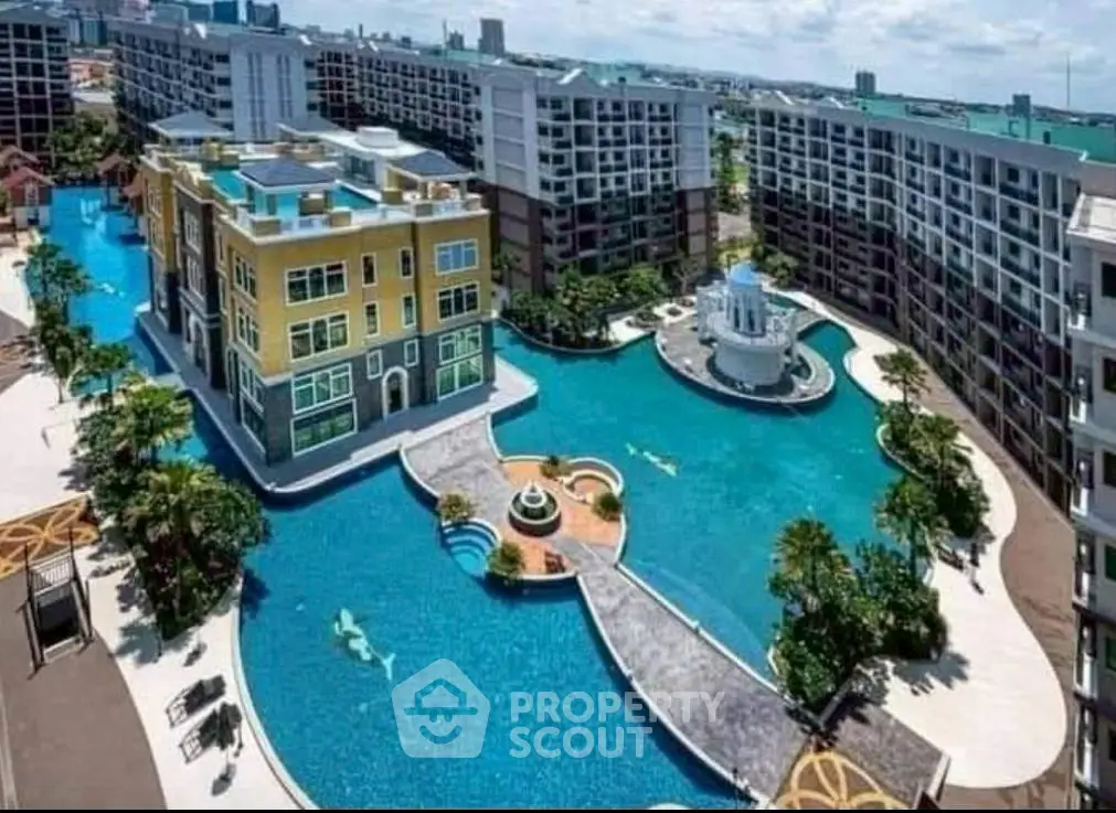 Luxurious apartment complex with expansive pool and stunning architectural design.