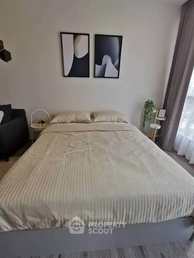 Modern bedroom with stylish decor and natural light, perfect for a cozy retreat.