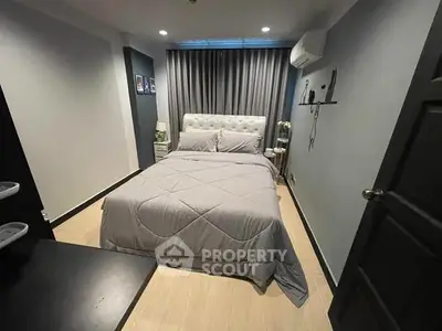 Cozy bedroom with modern decor and comfortable bed in stylish apartment.