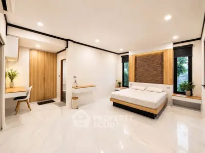 Spacious modern bedroom with elegant decor and natural light
