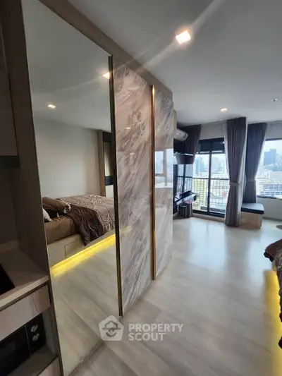 Modern bedroom with city view, featuring sleek design and large windows for natural light.