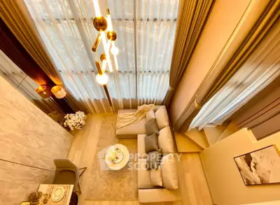 Luxurious high-ceiling living room with elegant decor and modern lighting