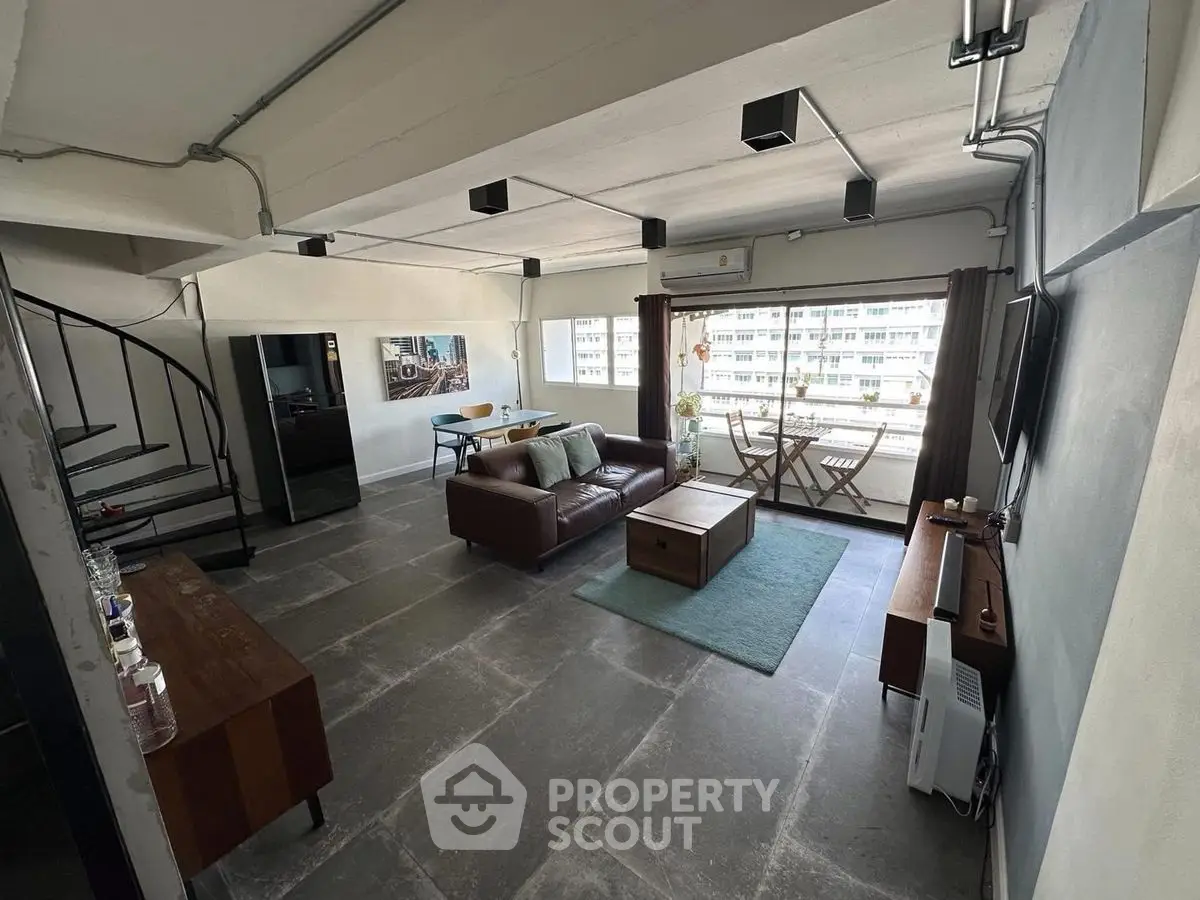 Spacious modern living room with balcony in urban apartment