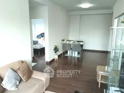 Spacious living room with modern dining area and cozy seating, perfect for relaxation and entertaining.