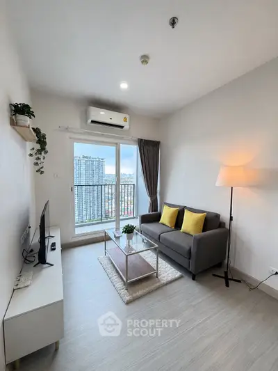 Modern living room with city view, stylish decor, and natural light.