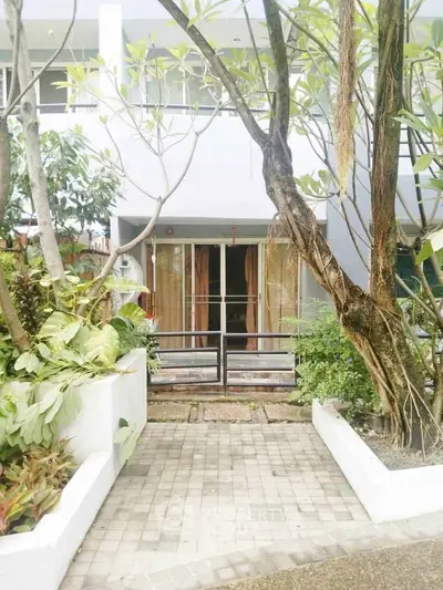 Charming exterior view of a modern home with lush greenery and inviting entrance.