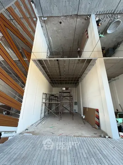 Modern construction site with scaffolding and unfinished interior, showcasing potential for customization.