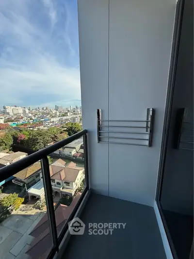 Stunning city view from a modern balcony with glass railing, perfect for urban living.
