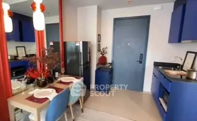 Modern kitchen with blue cabinets and dining area in stylish apartment
