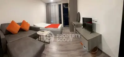 Modern studio apartment with cozy living area and stylish decor.