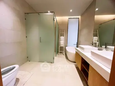 Luxurious modern bathroom with glass shower and freestanding bathtub