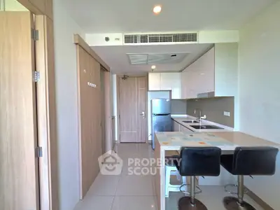 Modern kitchen with breakfast bar and sleek appliances in a stylish apartment.