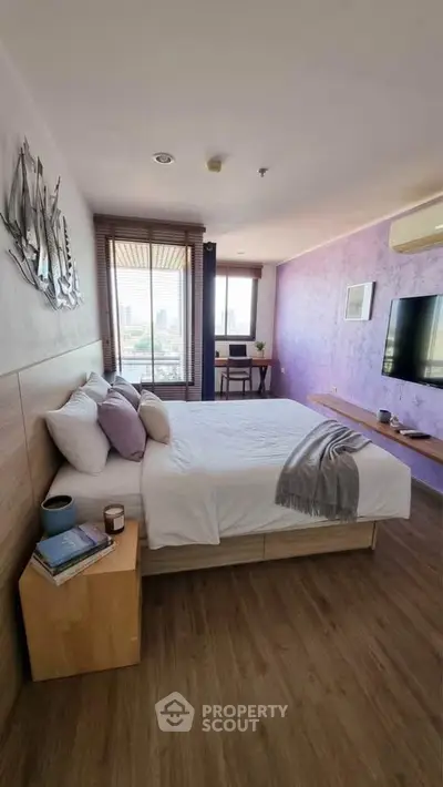 Spacious bedroom with city view, modern decor, and cozy ambiance, perfect for relaxation and comfort.