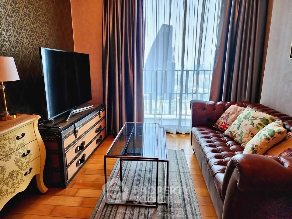 Luxurious living room with leather sofa, large TV, and city view through floor-to-ceiling windows.
