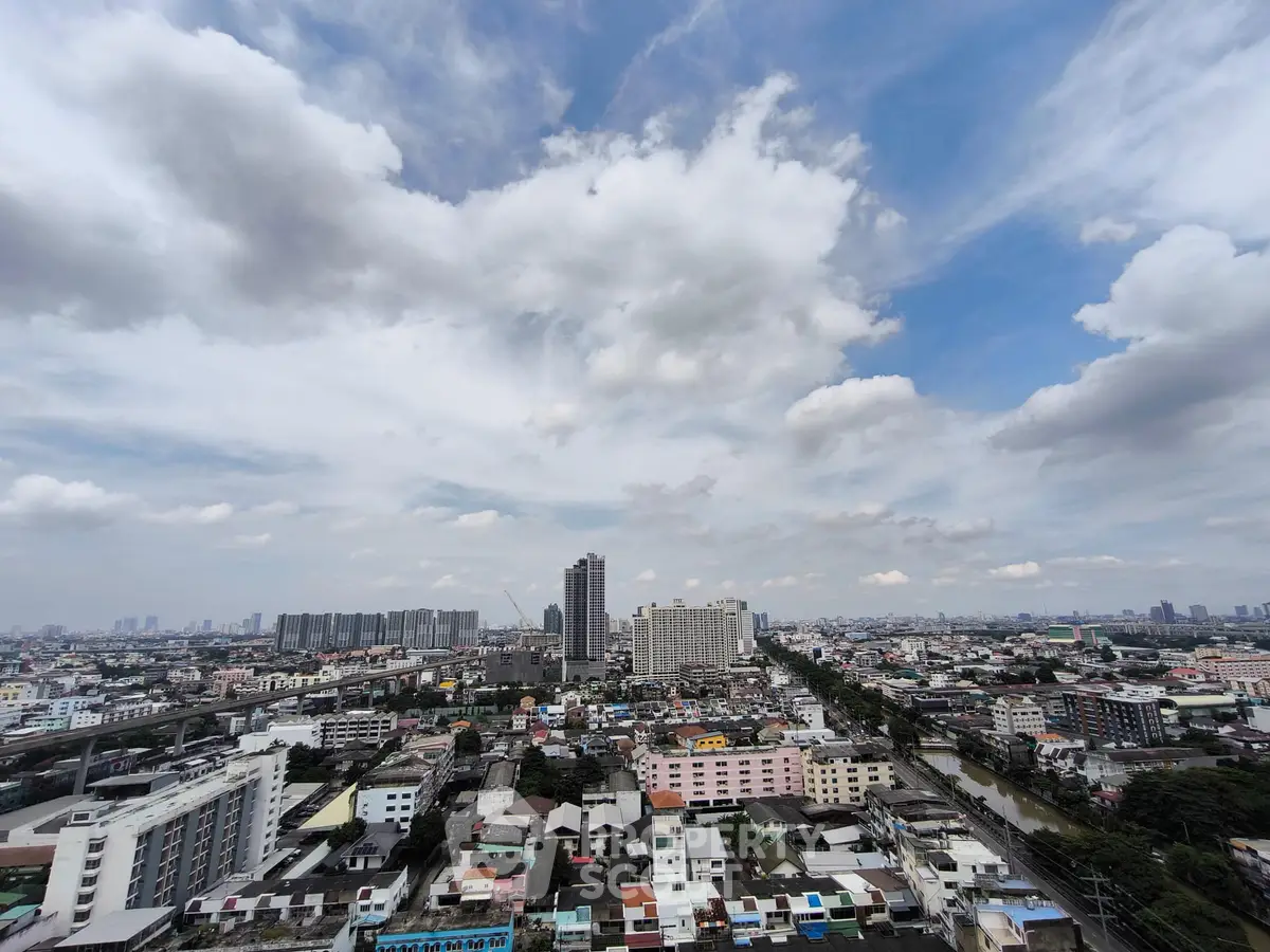 Stunning cityscape view showcasing urban skyline under a vibrant blue sky with clouds.