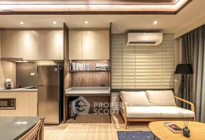 Modern living room with cozy sofa, air conditioning, and stylish kitchen area.