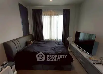 Cozy bedroom with modern decor and large window for natural light