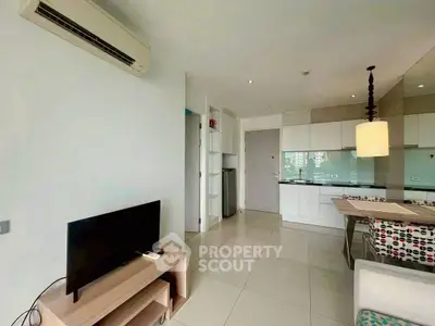 Modern open-layout living room with sleek kitchen and stylish decor