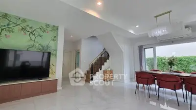 Spacious modern living room with elegant dining area and stylish staircase