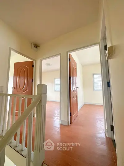 Spacious interior with wooden doors and bright natural light, ideal for modern living.