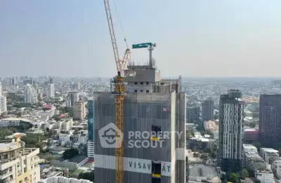 High-rise building under construction with city skyline view