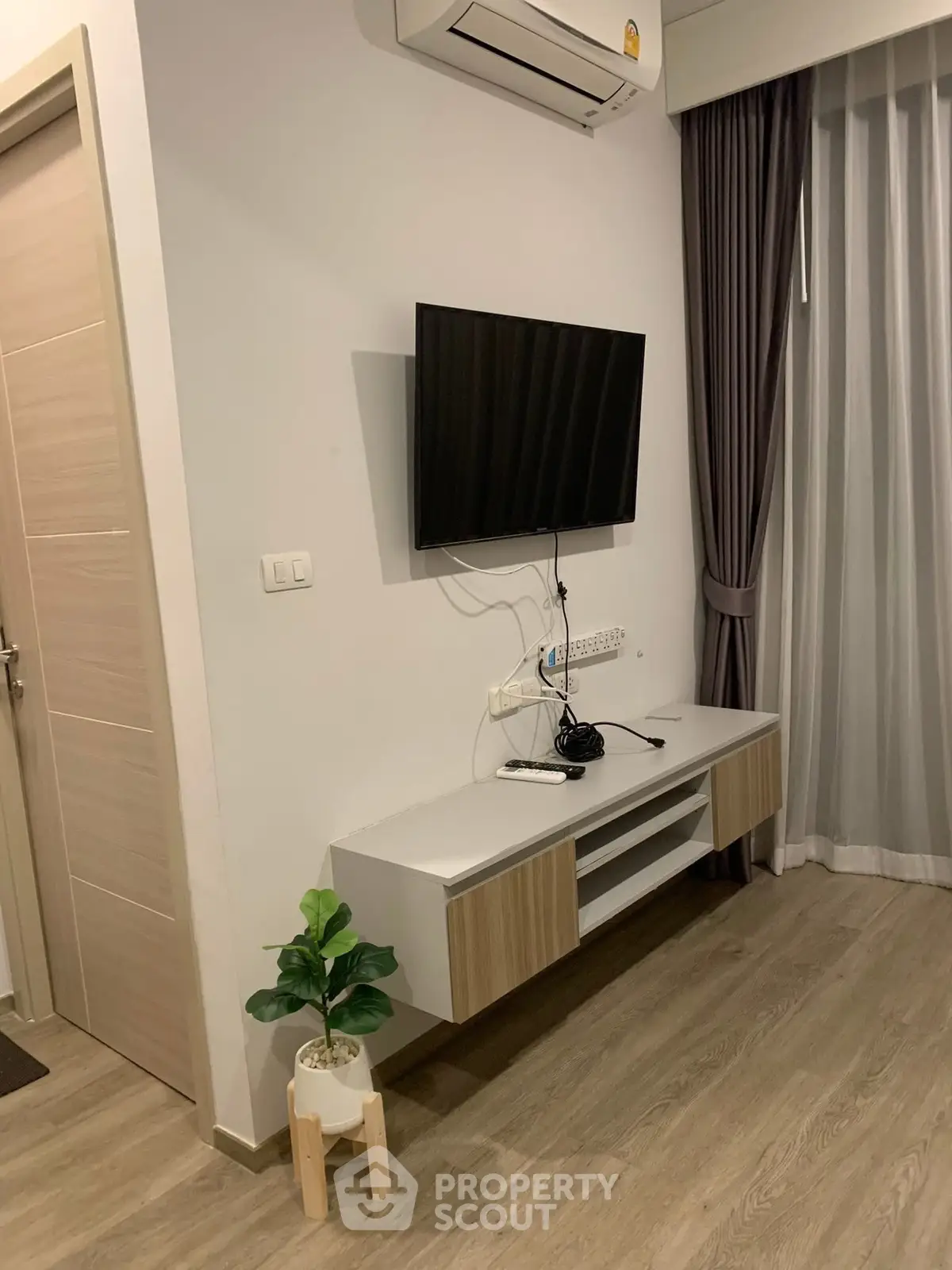 Modern living room with wall-mounted TV and stylish decor