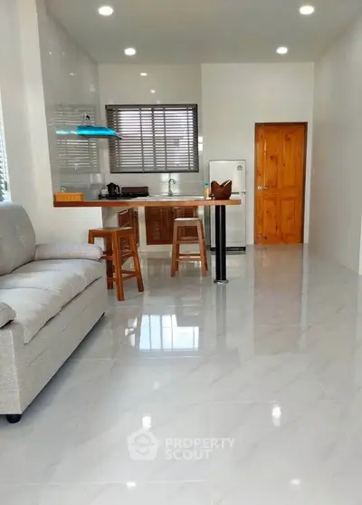 Modern open-plan kitchen and living area with sleek finishes and natural light.