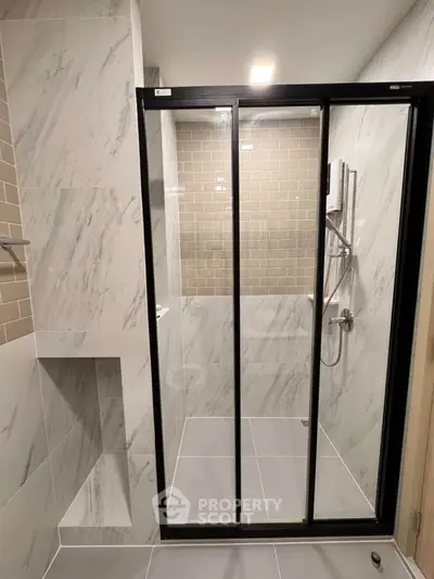 Modern bathroom with sleek shower enclosure and stylish tile design