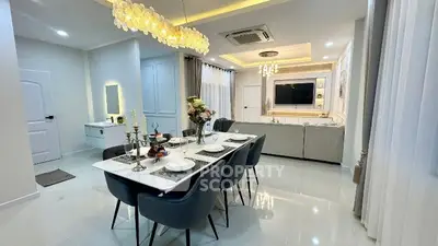Elegant dining and living area with modern decor and ambient lighting