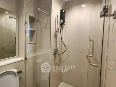 Modern bathroom with glass shower enclosure and sleek fixtures