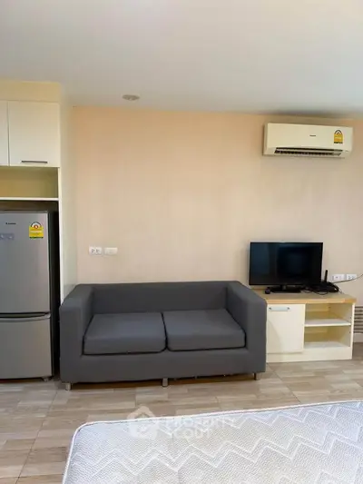 Modern studio apartment with compact living area and air conditioning