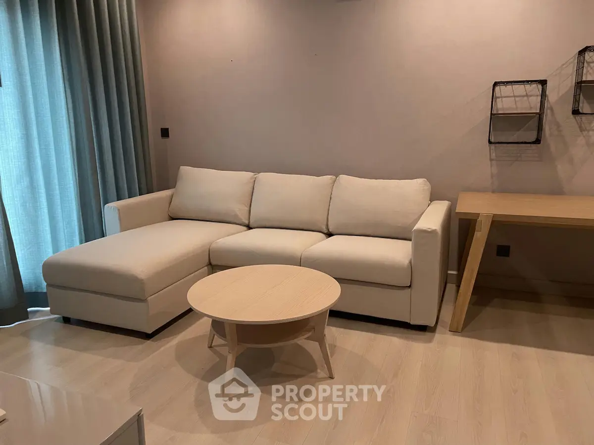Modern living room with stylish sofa and wooden furniture, perfect for cozy relaxation.