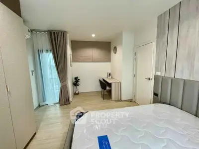 Modern bedroom with stylish decor and natural light, featuring a cozy workspace and elegant furnishings.