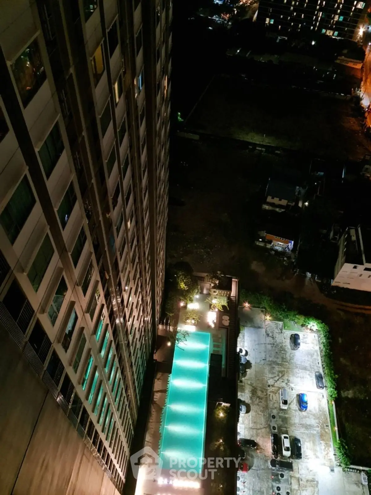 Stunning high-rise building with illuminated pool and city view at night