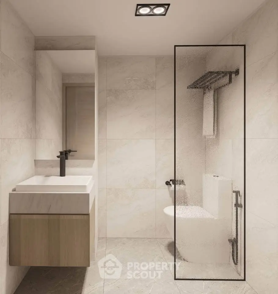Modern minimalist bathroom with sleek fixtures and glass shower partition