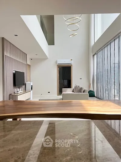 Luxurious modern living room with high ceilings and elegant decor